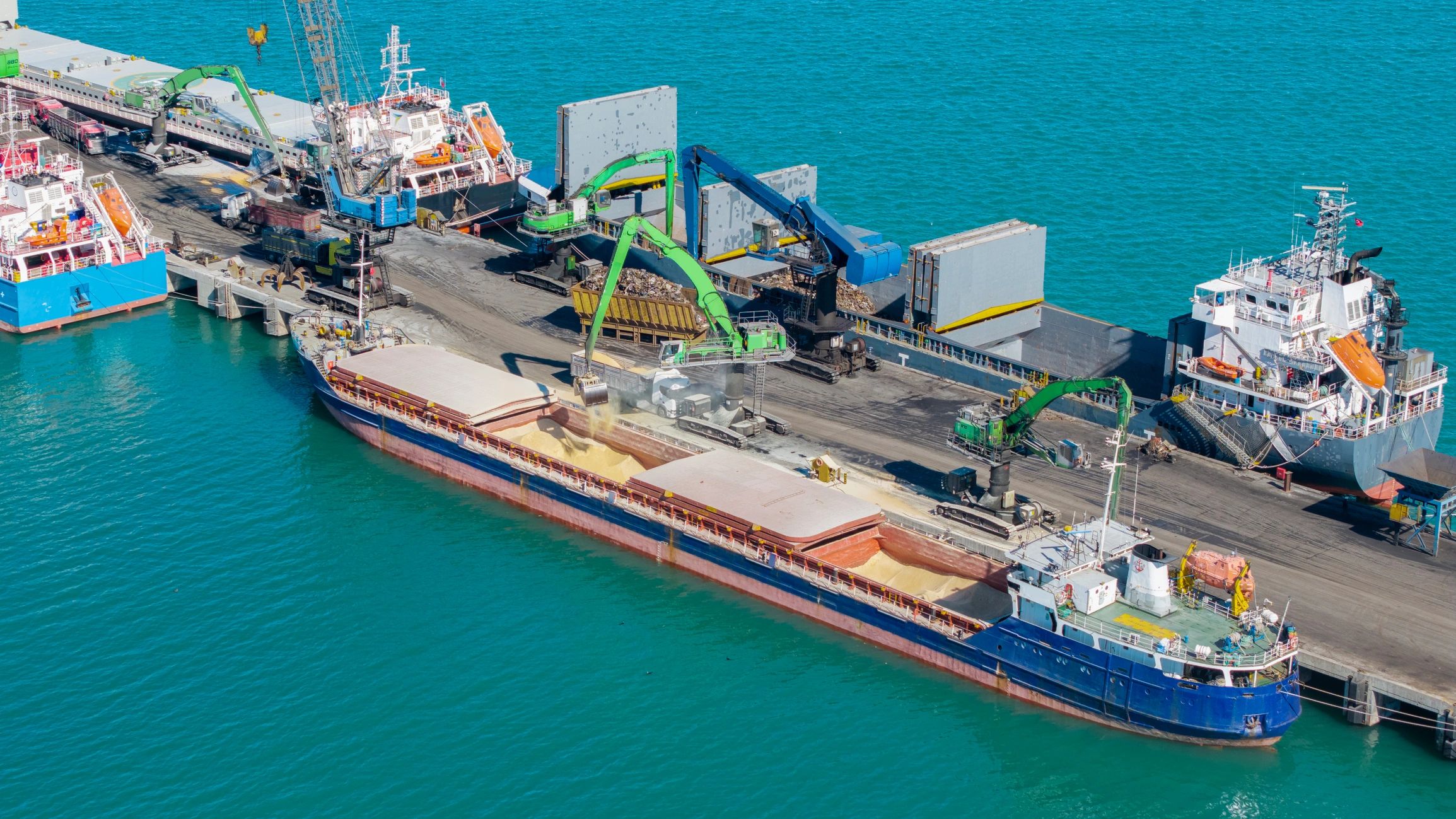 Cargo ship loading in an industrial port harbor