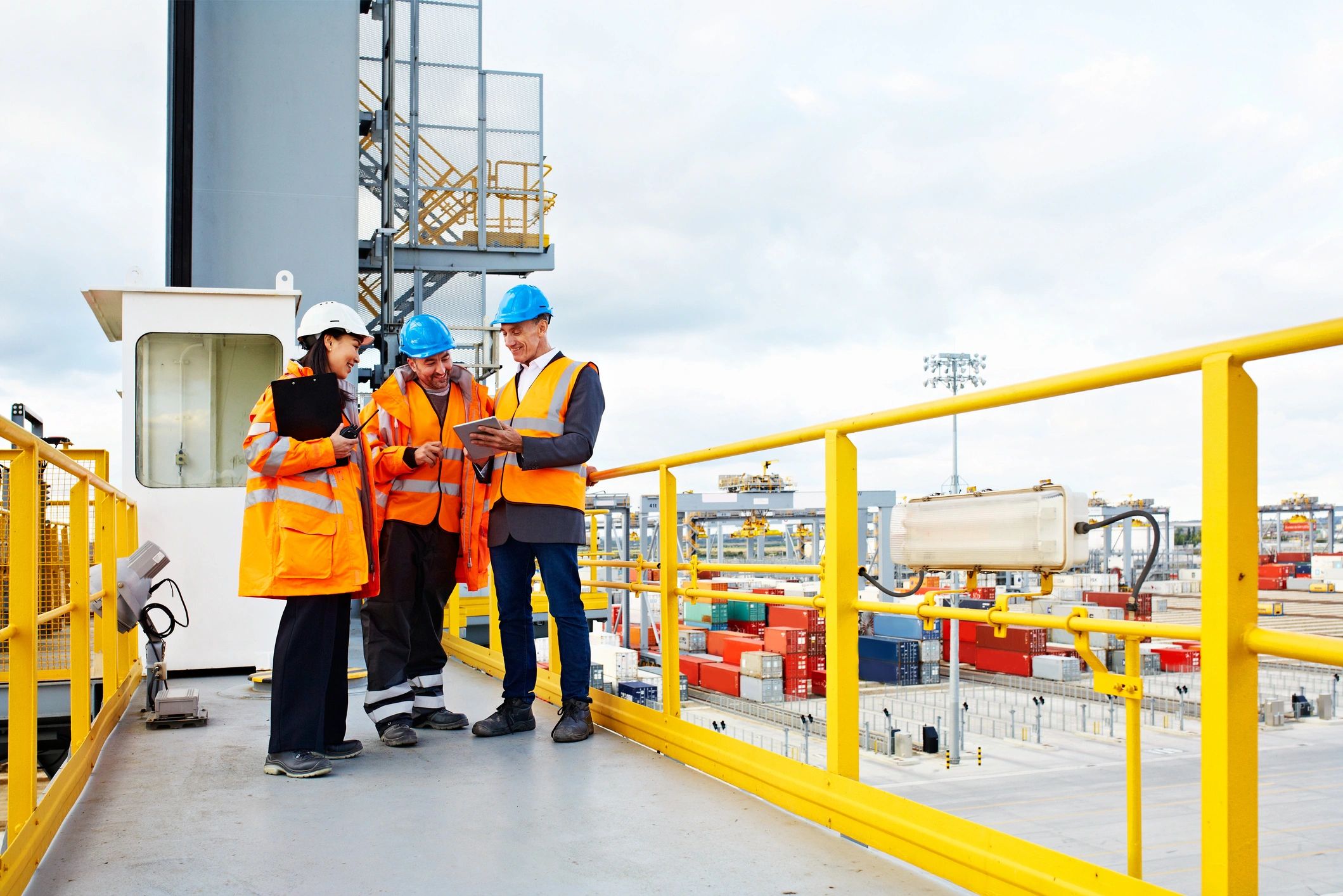 Workers reviewing logistics details on a commercial dock